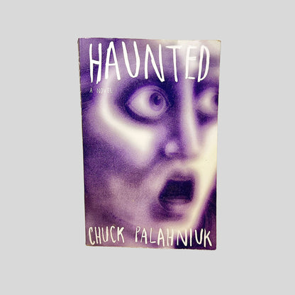 Front cover view of Haunted by Chuck Palahniuk centered on a neutral light gray background. 