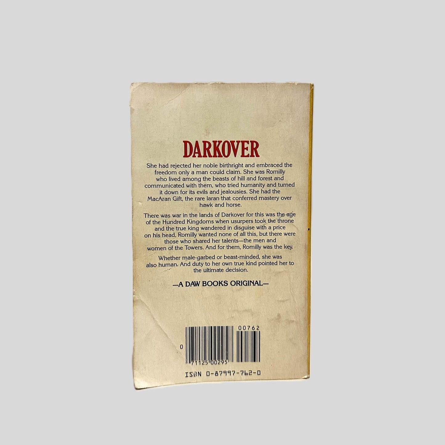 Back cover view of Hawkmistress! by Marion Zimmer Bradley centered on a neutral light gray background. Chipping present around the edges. Creasing at the corners.