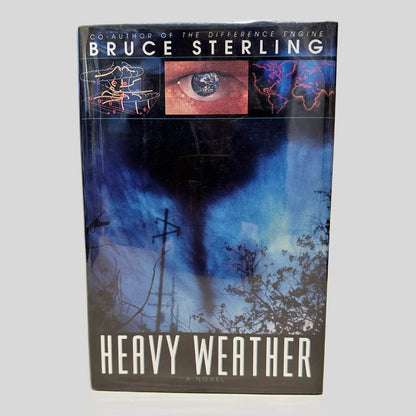 Front cover view of Heavy Weather by Bruce Sterling centered on a neutral light gray background. Dust jacket is present and undamaged.
