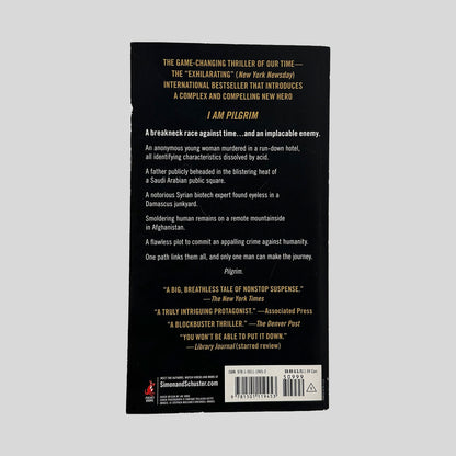 The black back cover of I Am Pilgrim, displaying a series of ominous plot points and critical praise from The New York Times and Library Journal in gold and white text.