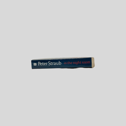 The dark blue spine of the book In the Night Room by Peter Straub, featuring the title in red and the author's name in white serif font.