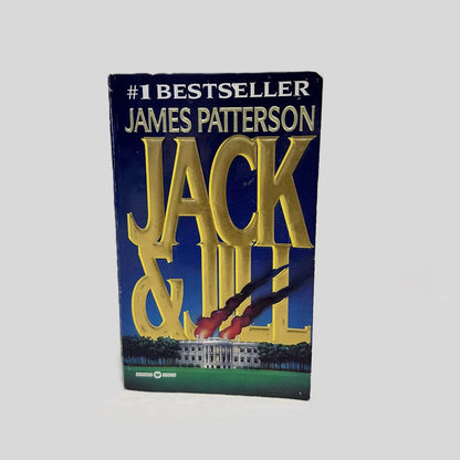 Front cover view of Jack & Jill by James Patterson centered on a neutral light gray background. Some chipping is present on the corners of the front cover.