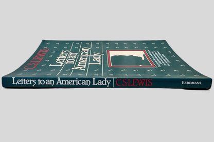 Close-up spine view of Letters to an American Lady by C.S. Lewis centered on a neutral light gray background. Spine shows no creasing. 