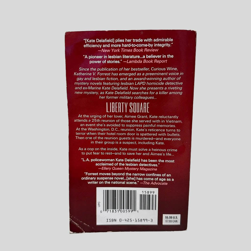 Back cover view of Liberty Square by Katherine V. Forrest centered on a neutral light gray background. Creasing on bottom left corner.