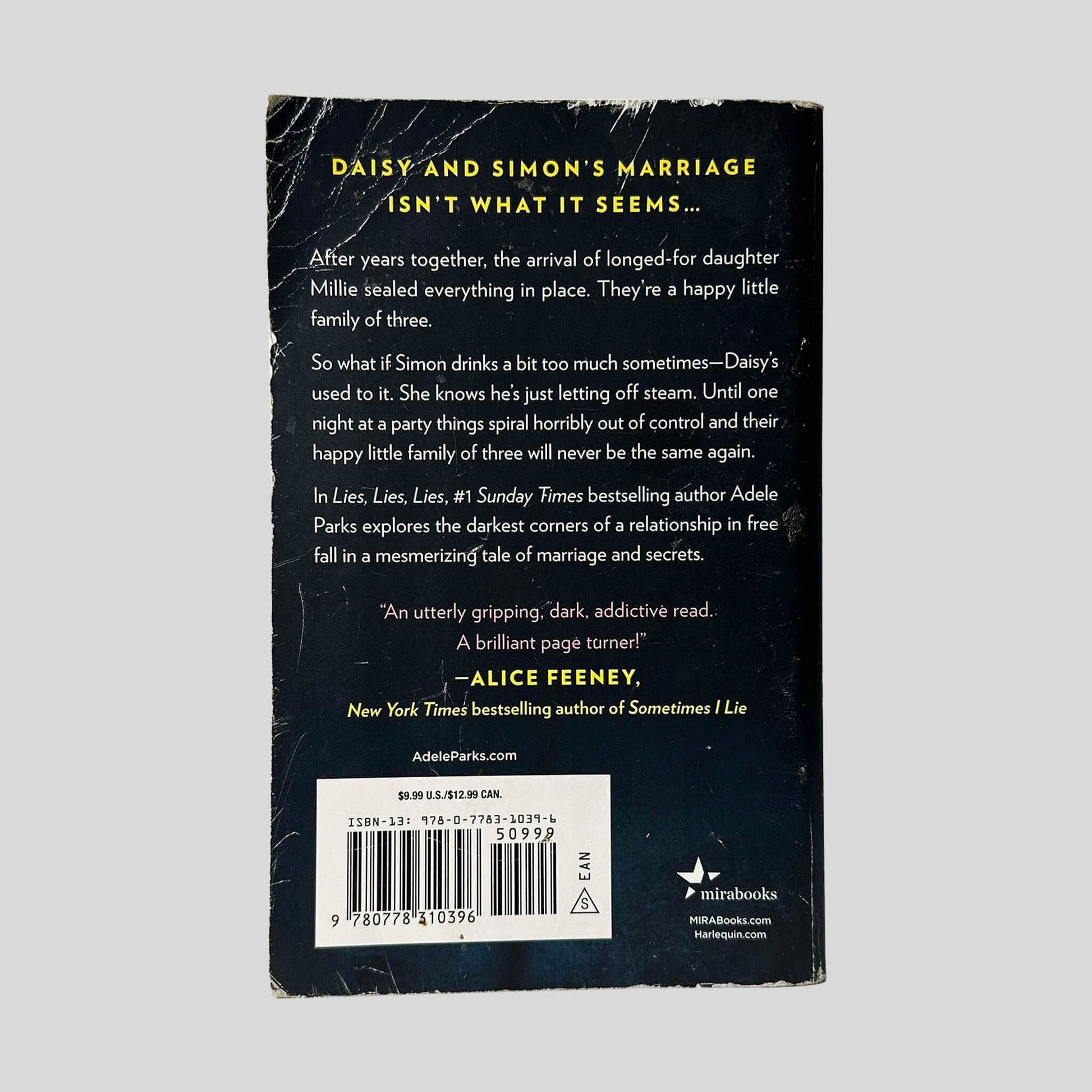 Back cover view of Lies Lies Lies by Adele Parks centered on a neutral light gray background. Chipping along the edges of the back cover. Creasing along the top left corner.