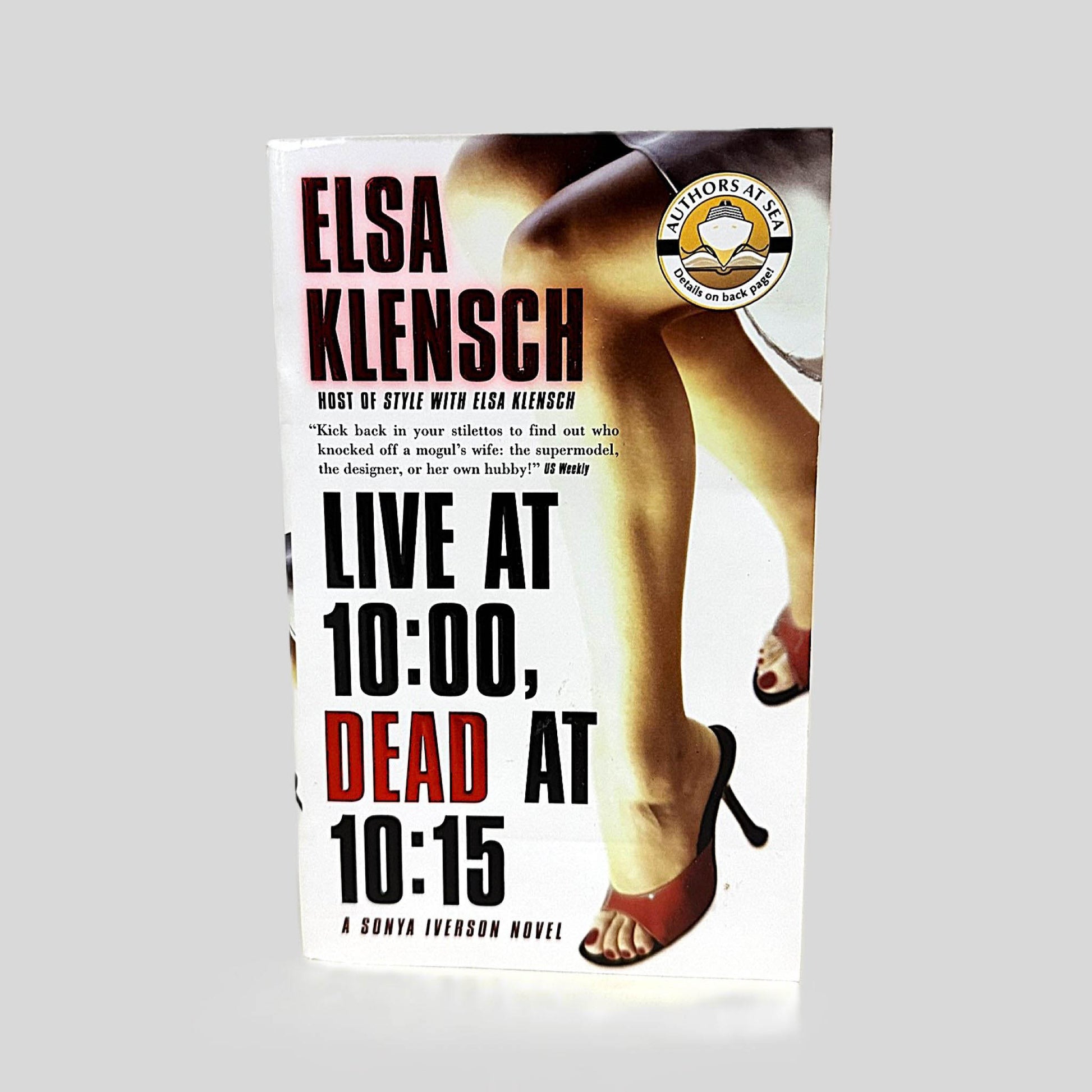 Front cover view of Live at 10:00, Dead at 10:15 by Elsa Klensch centered on a neutral light gray background. 