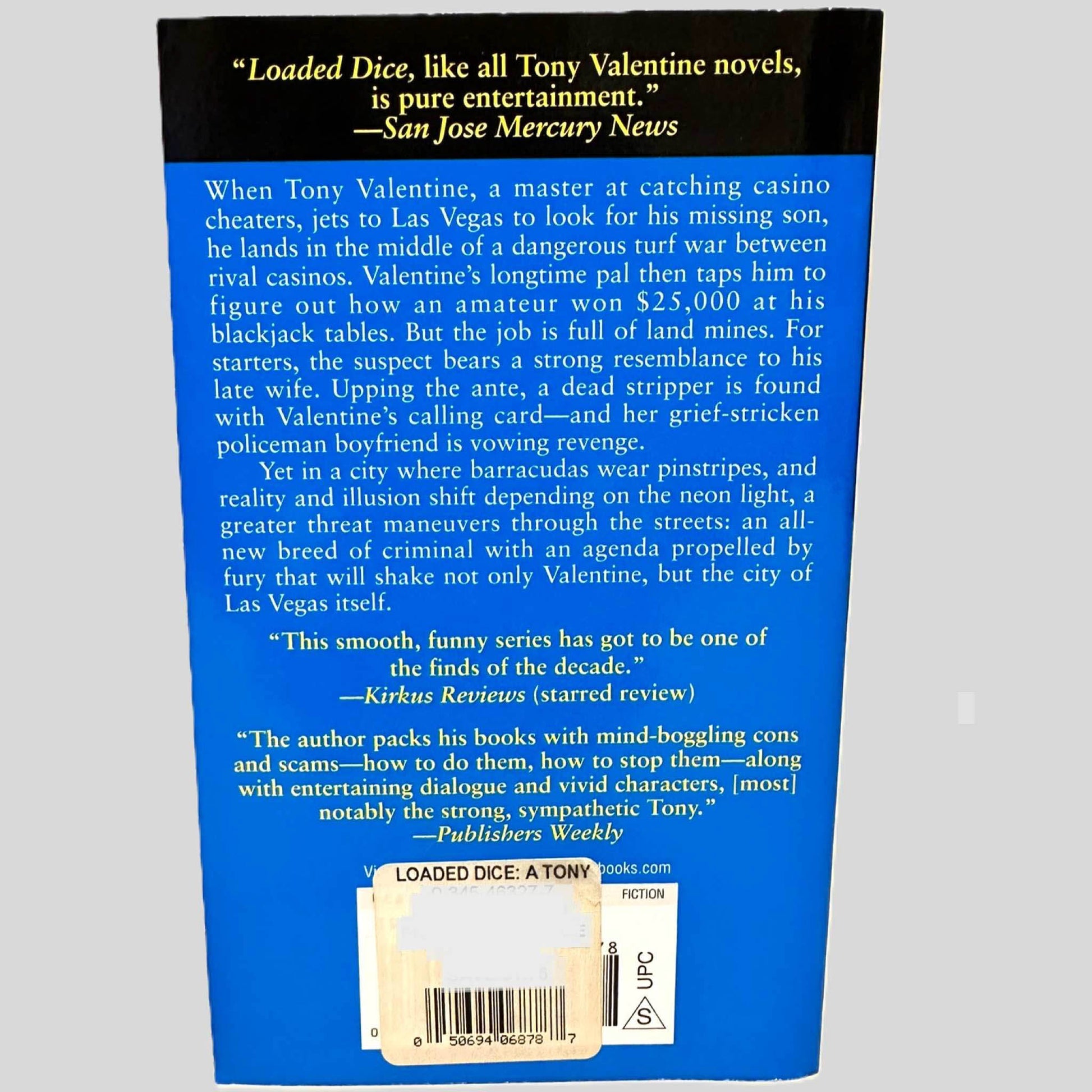 Back cover view of Loaded Dice by James Swain centered on a neutral light gray background. 