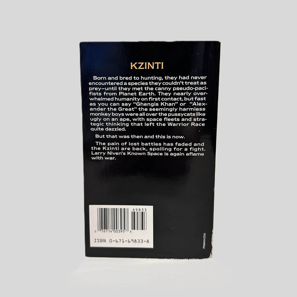 Back cover view of Man-Kzin Wars II by Larry Niven centered on a neutral light gray background. Chipping in the bottom right corner, near the spine.