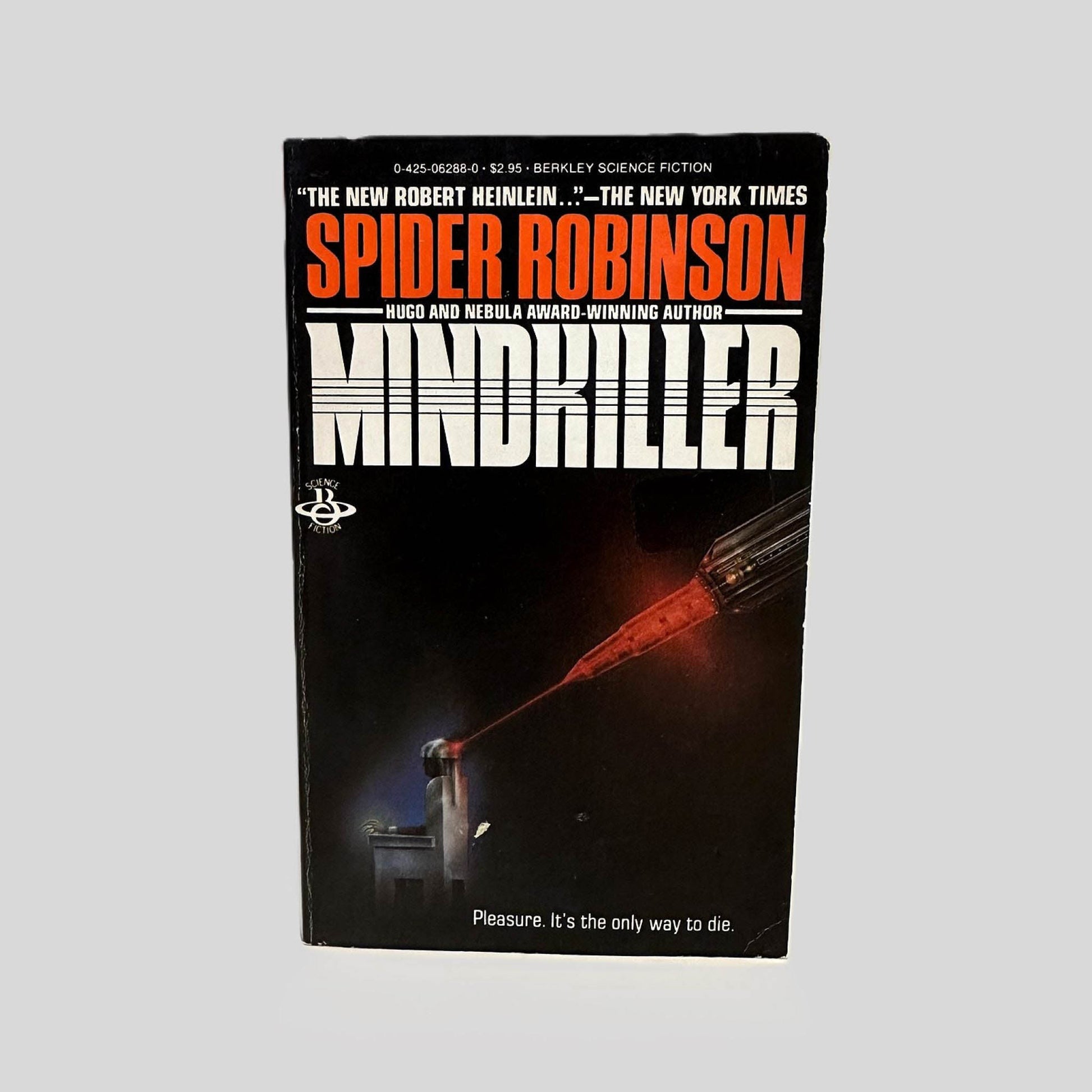Front cover view of Mindkiller by Spider Robinson centered on a neutral light gray background. Minor chipping is present from age. Cover art is vibrant.