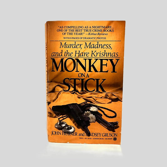 Front cover view of Monkey on a Stick by John Hubner & Lindsey Gruson centered on a neutral light gray background. Front cover shows chipping.