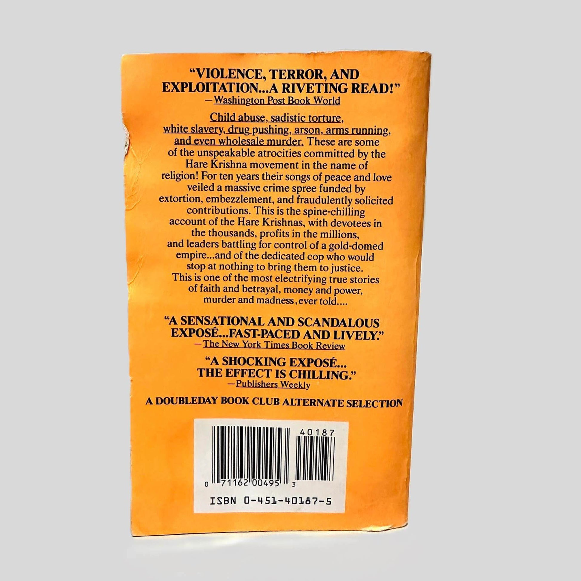 Back cover view of Monkey on a Stick by John Hubner & Lindsey Gruson centered on a neutral light gray background. Back cover shows chipping.