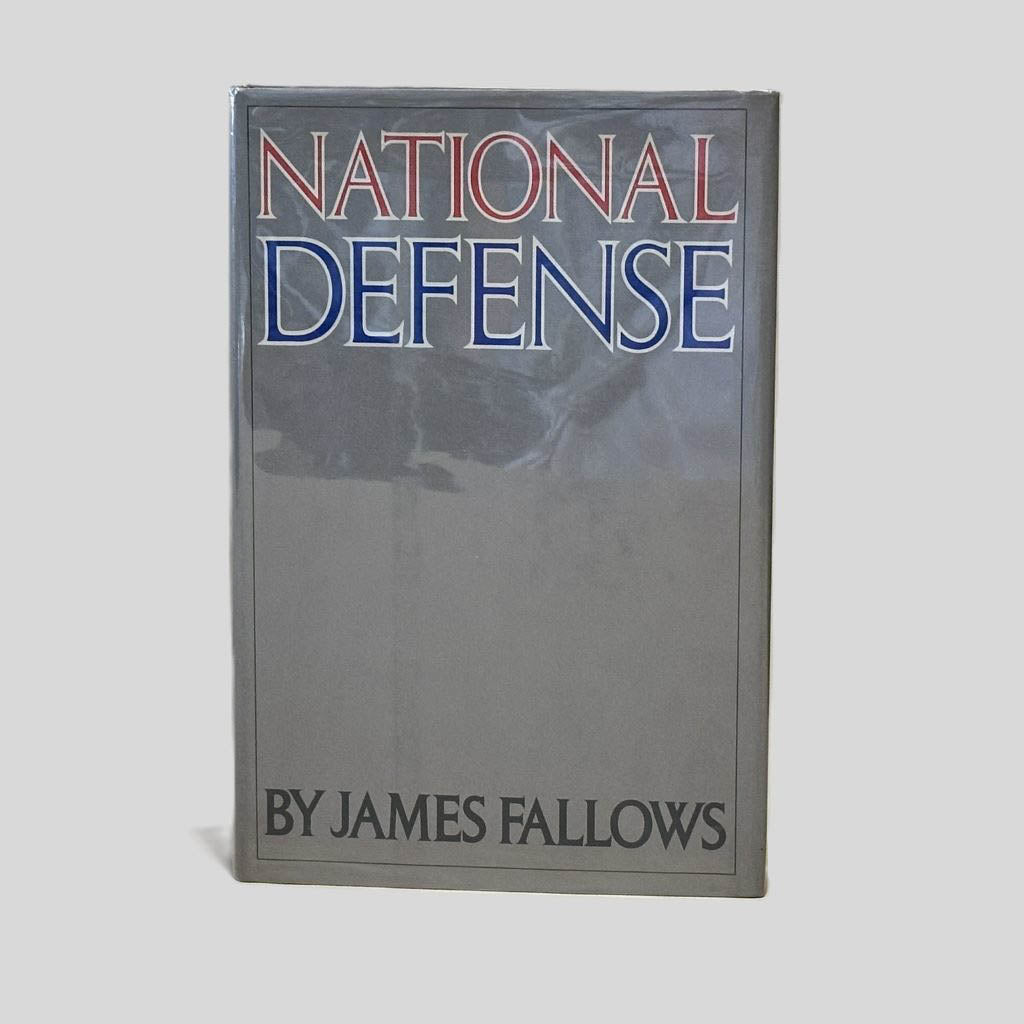 Front cover view of National Defense by James Fallows centered on a neutral light gray background. Dust jacket is present and shows no damage.