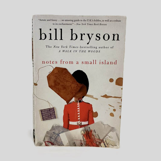 Front cover view of Notes from a Small Island by Bill Bryson centered on a neutral light gray background. Minor chipping around the edges from wear.