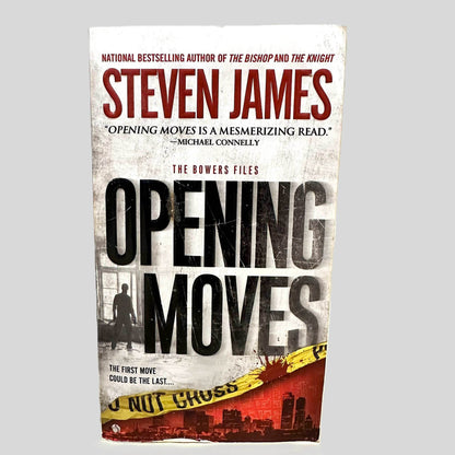 Front cover view of Opening Moves by Steven James centered on a neutral light gray background. Chipping is present along the bottom edge of the front cover.