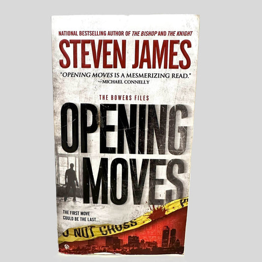 Front cover view of Opening Moves by Steven James centered on a neutral light gray background. Chipping is present along the bottom edge of the front cover.