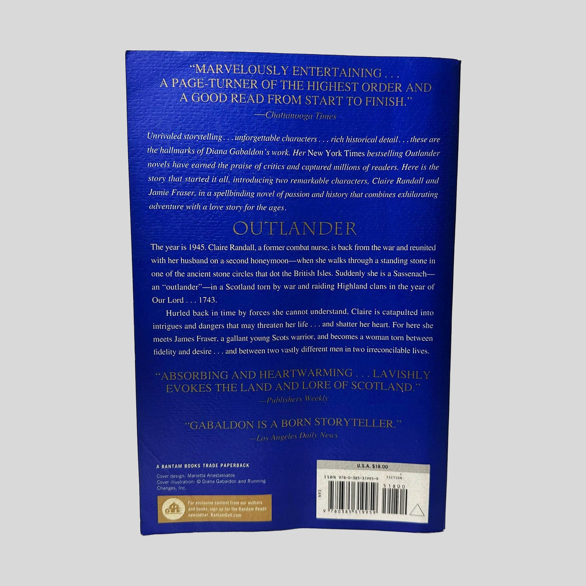 Back cover view of Outlander by Diana Gabaldon centered on a neutral light gray background. Creasing along bottom left corner. Slight wave is present.