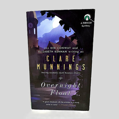 Front cover view of Overnight Float by Clare Munnings centered on a neutral light gray background. Minor chipping on the top corner of the cover.