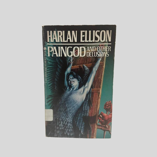 Front cover view of Paingod and Other Delusions by Harlan Ellison centered on a neutral light gray background. Creasing near the spine. Minor chipping around the edges. Cover art is vibrant.