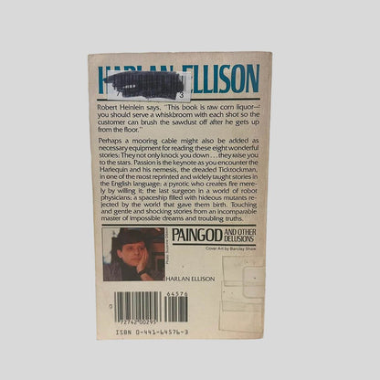 Back cover view of Paingod and Other Delusions by Harlan Ellison centered on a neutral light gray background. Normal chipping wear around the edges from age. Library barcode sticker in the top right corner colored over with black ink. 