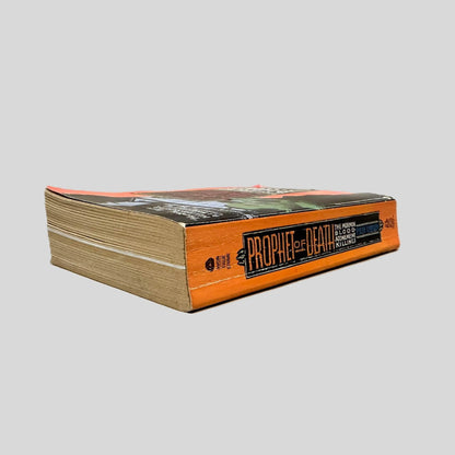 Close-up spine view of Prophet of Death by Pete Earley centered on a neutral light gray background. Spine shows creasing.