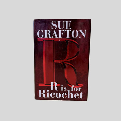 Front cover view of R is for Ricochet by Sue Grafton centered on a neutral light gray background. Dust jacket is present and undamaged. 