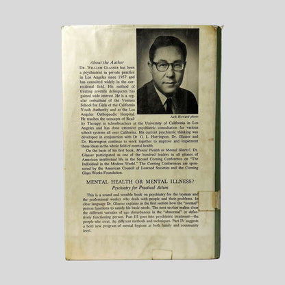 Back cover view of Reality Therapy by William Glasser, M.D. centered on a neutral light gray background. Dust jacket is present with library mylar cover. Fraying from wear to the jacket is present at the corners.