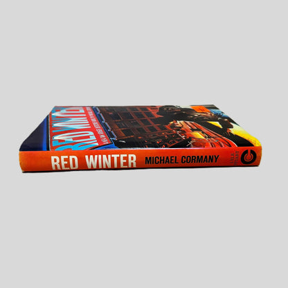 Close-up spine view of Red Winter by Michael Cormany centered on a neutral light gray background. Dust jacket is present and undamaged.
