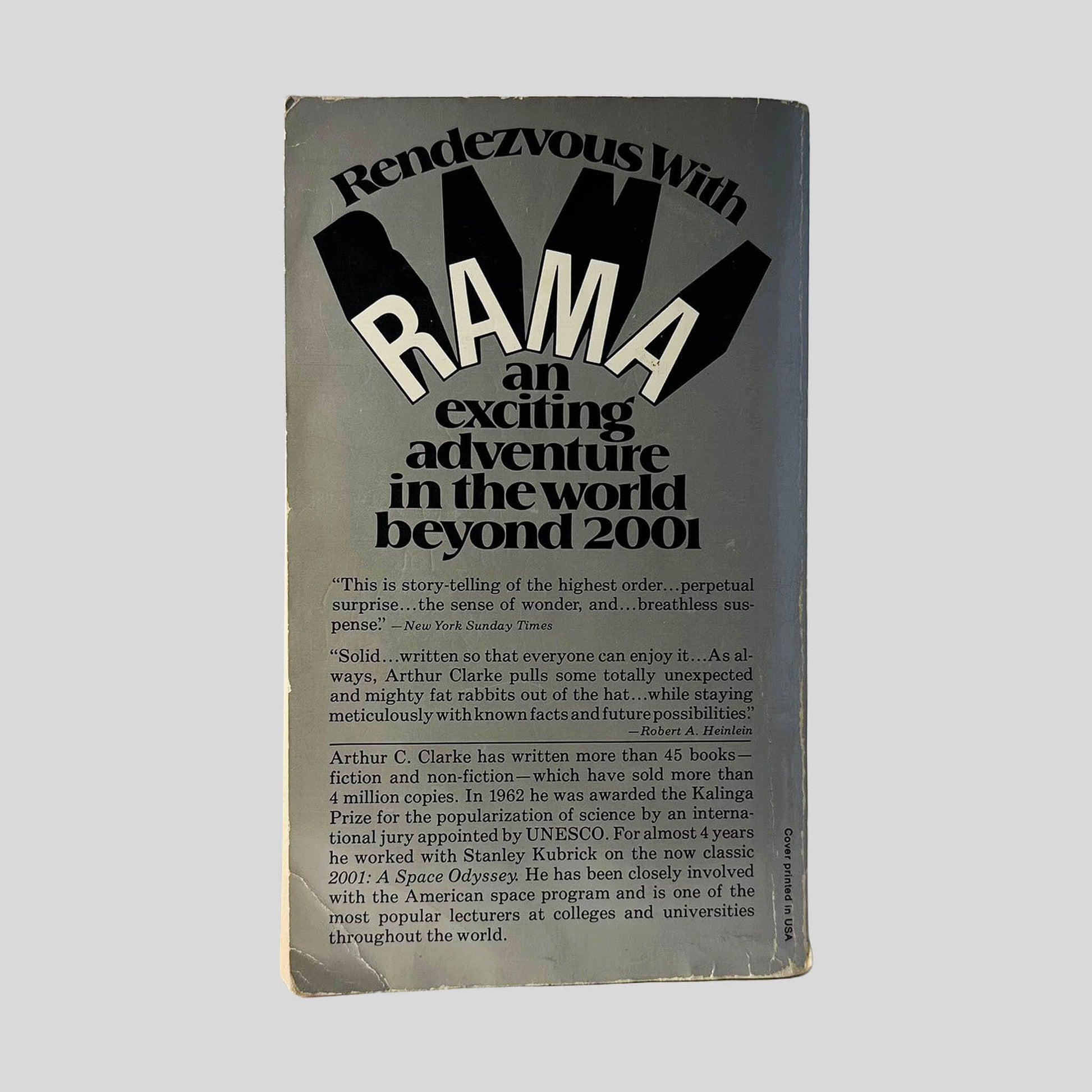 Back cover view of Rendezvous With Rama by Arthur C. Clarke centered on a neutral light gray background. Normal creasing and chipping from wear around the edges.