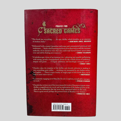 Back cover view of Sacred Games by Vikram Chandra centered on a neutral light gray background. Dust jacket present and undamaged.