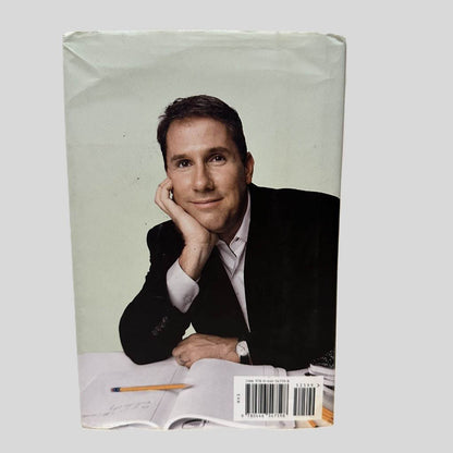 Back cover view of Safe Haven by Nicholas Sparks centered on a neutral light gray background. Dust jacket is present. Creasing in the top left and right corners.