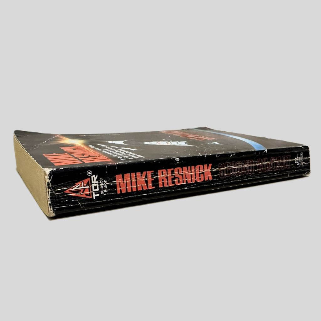 Close-up spine view of Second Contact by Mike Resnick centered on a neutral light gray background. Spine shows creasing and chipping at the top of spine. Pages lay flat.