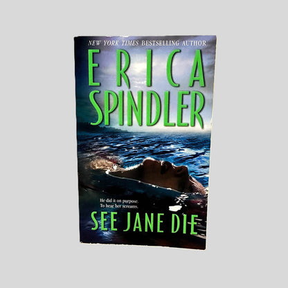 Front cover view of See Jane Die by Erica Spindler centered on a neutral light gray background. Minimal chipping to the top edge of the cover.