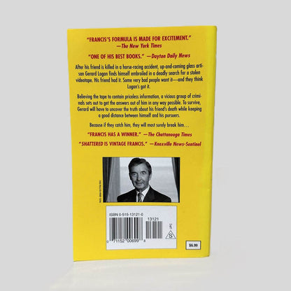 Back cover view of Shattered by Dick Francis centered on a neutral light gray background. 