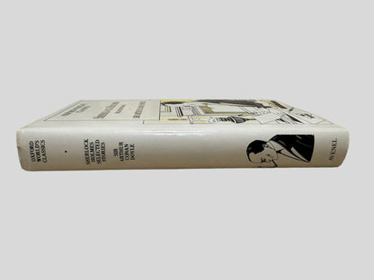 Close-up spine view of Sherlock Holmes Selected Stories by Sir Arthur Conan Doyle centered on a neutral light gray background. Dust jacket is present and shows no damage. Spine shows no creasing. Pages lay flat.