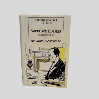 Front cover view of Sherlock Holmes Selected Stories by Sir Arthur Conan Doyle centered on a neutral light gray background. Dust jacket is present and shows minor crease in the top right of the front cover.
