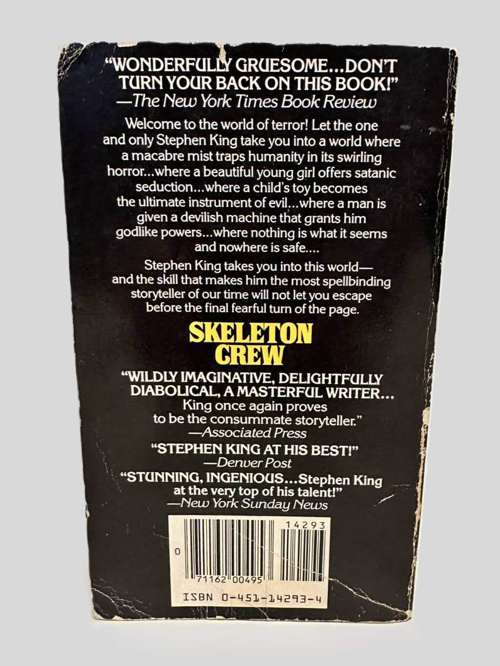 Back cover view of Skeleton Crew by Stephen King centered on a neutral light gray background. Creasing, chipping, rubbing present.