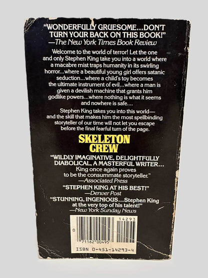 Back cover view of Skeleton Crew by Stephen King centered on a neutral light gray background. Creasing, chipping, rubbing present.