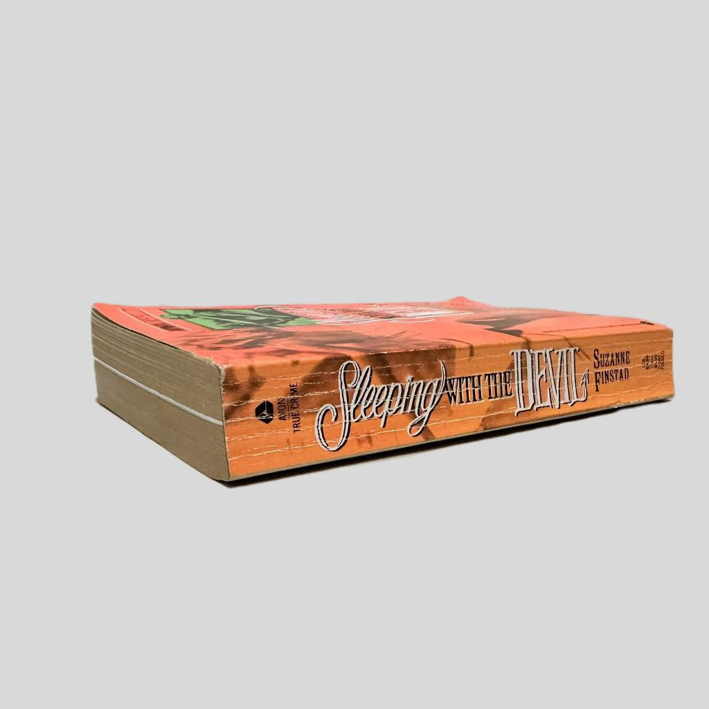 Close-up spine view of Sleeping with the Devil by Suzanne Finstad centered on a neutral light gray background. Spine shows creasing.