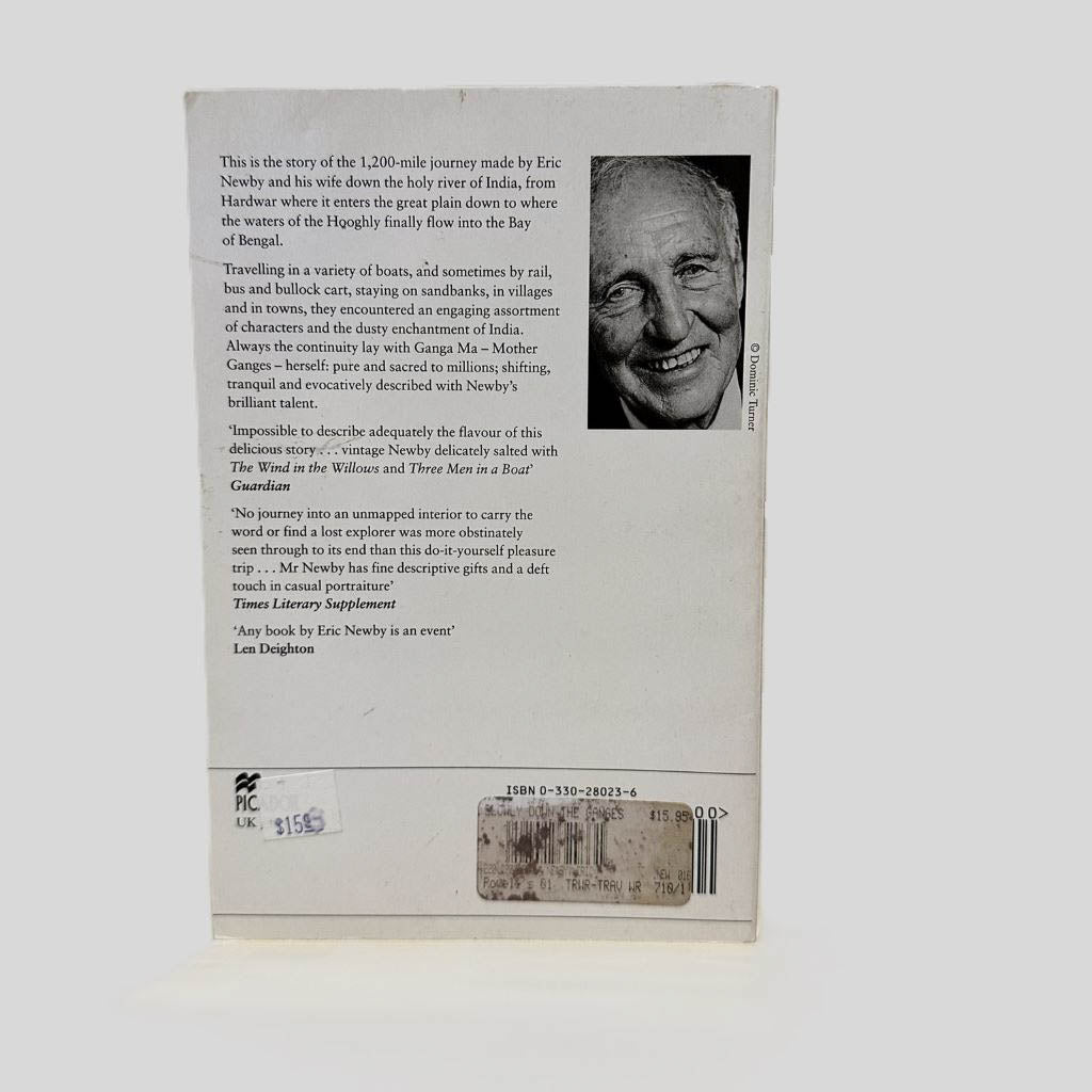 Back cover view of Slowly Down the Ganges by Eric Newby centered on a neutral light gray background. Chipping is present along the top edge.