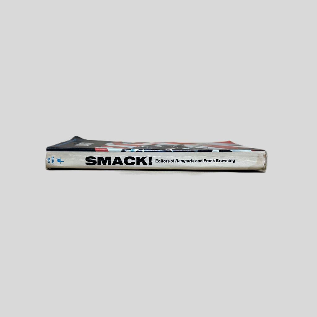 Close-up spine view of Smack by Frank Browning centered on a neutral light gray background. Spine shows minimal creasing and is square. Some light bumping.