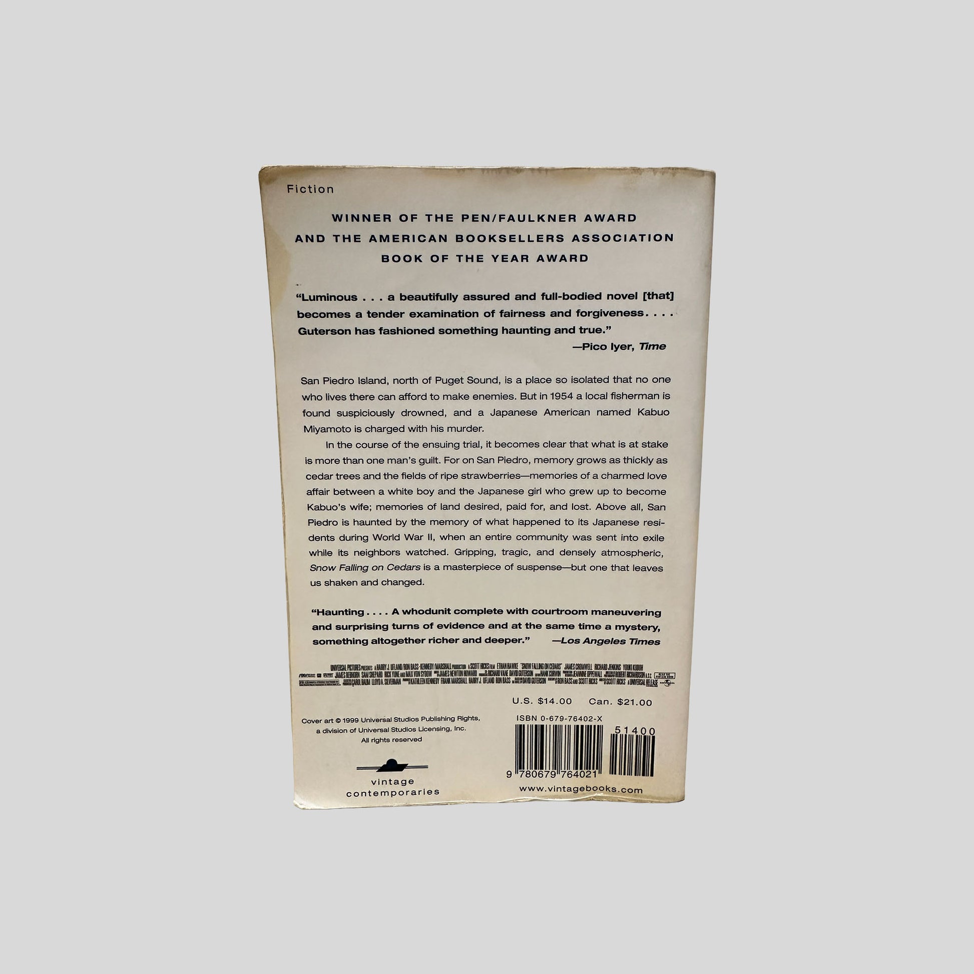 Back cover view of Snow Falling On Cedars by David Guterson centered on a neutral light gray background. 