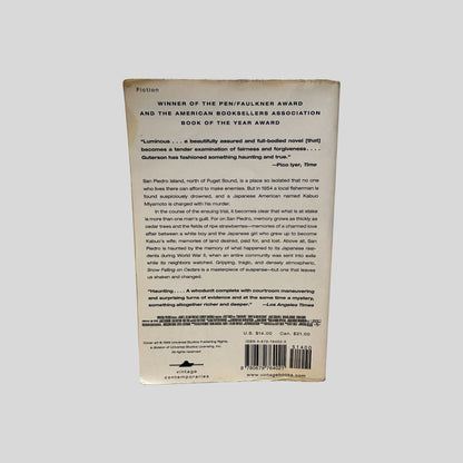 Back cover view of Snow Falling On Cedars by David Guterson centered on a neutral light gray background. 