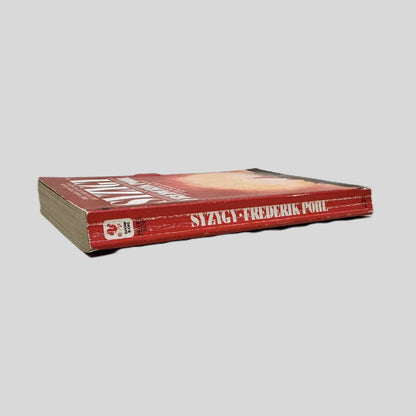 Close-up spine view of Syzygy by Frederik Pohl centered on a neutral light gray background. Spine shows creasing. Pages lay flat.