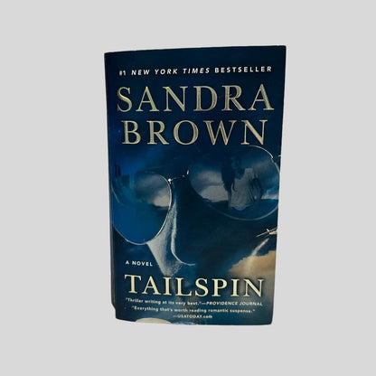 Front cover view of Tailspin by Sandra Brown centered on a neutral light gray background. 