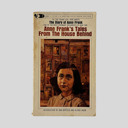The front cover of the Bantam Pathfinder edition of "Anne Frank's Tales From The House Behind," featuring a painted portrait of Anne Frank in front of dark Amsterdam canal houses.