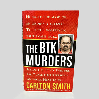 Front cover view of The BTK Murders by Carlton Smith centered on a neutral light gray background. 