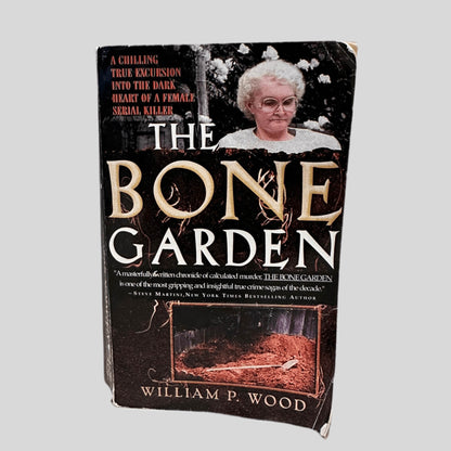 Front cover view of The Bone Garden by William P. Wood centered on a neutral light gray background. Cover shows creasing and rubbing.