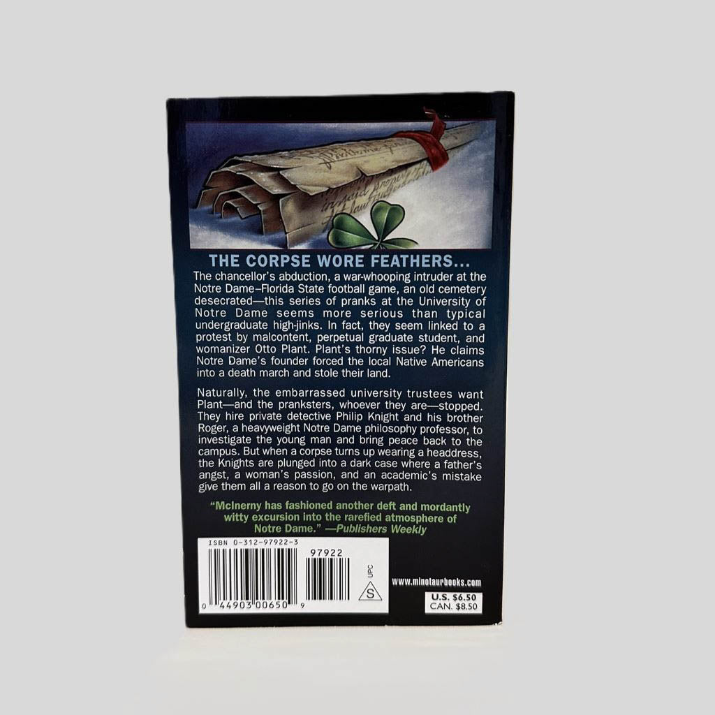 Back cover view of The Book of Kills by Ralph McInerny centered on a neutral light gray background. 