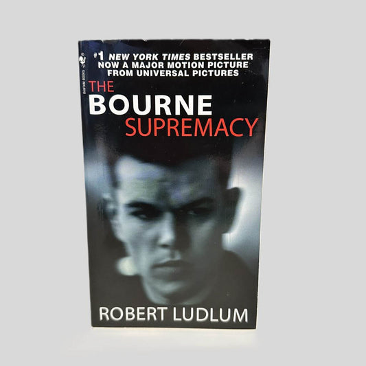 Front cover view of The Bourne Supremacy by Robert Ludlum centered on a neutral light gray background. 