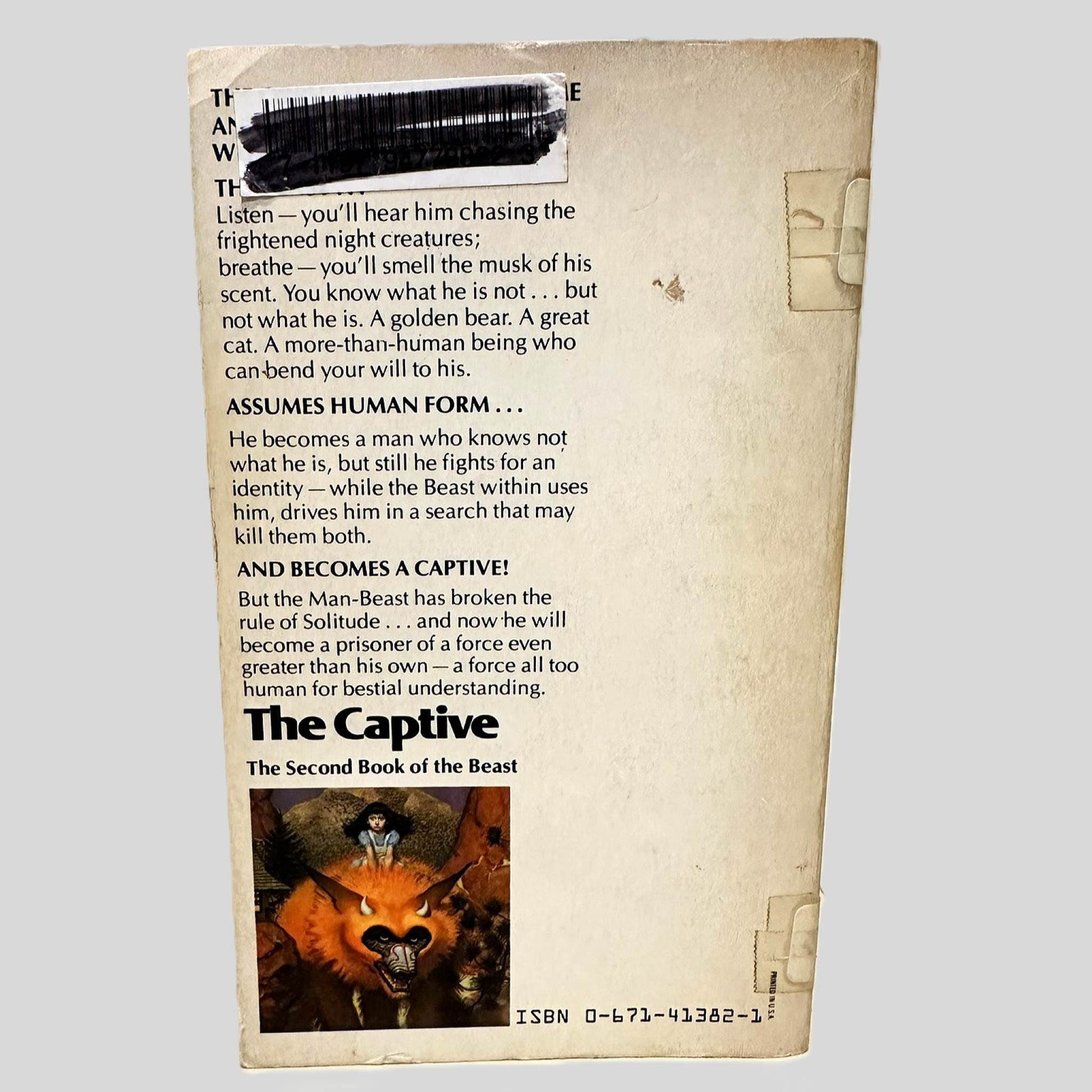 Back cover view of The Captive by Robert Stallman centered on a neutral light gray background. Chipping and creasing around the edges. Library barcode sticker in the top left corner, colored over with black ink. 